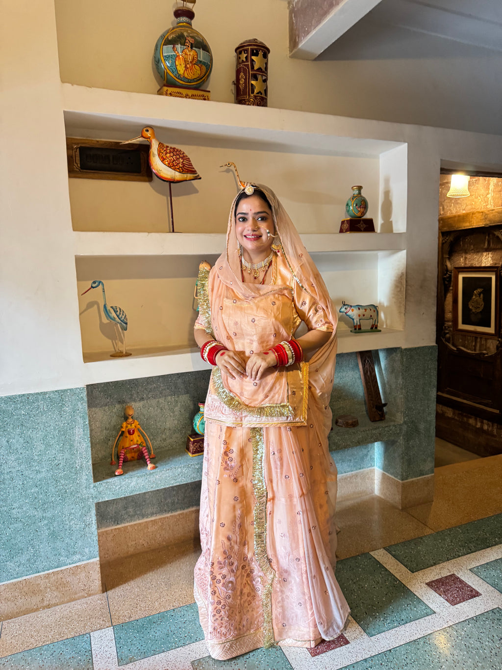 Bindani Elegant Peach Tissue Poshak with Button-Embellished Odhna