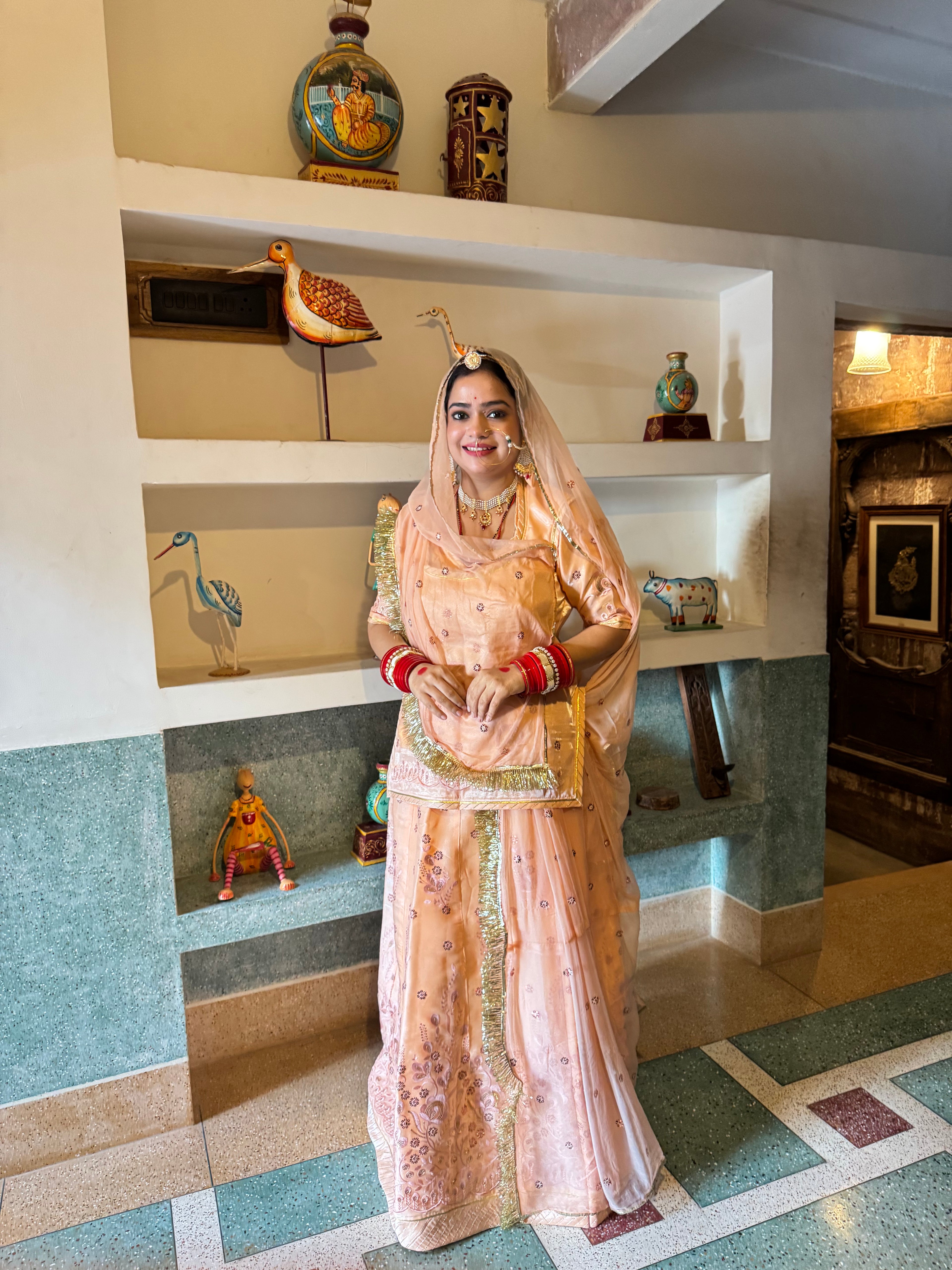 Bindani Elegant Peach Tissue Poshak with Button-Embellished Odhna