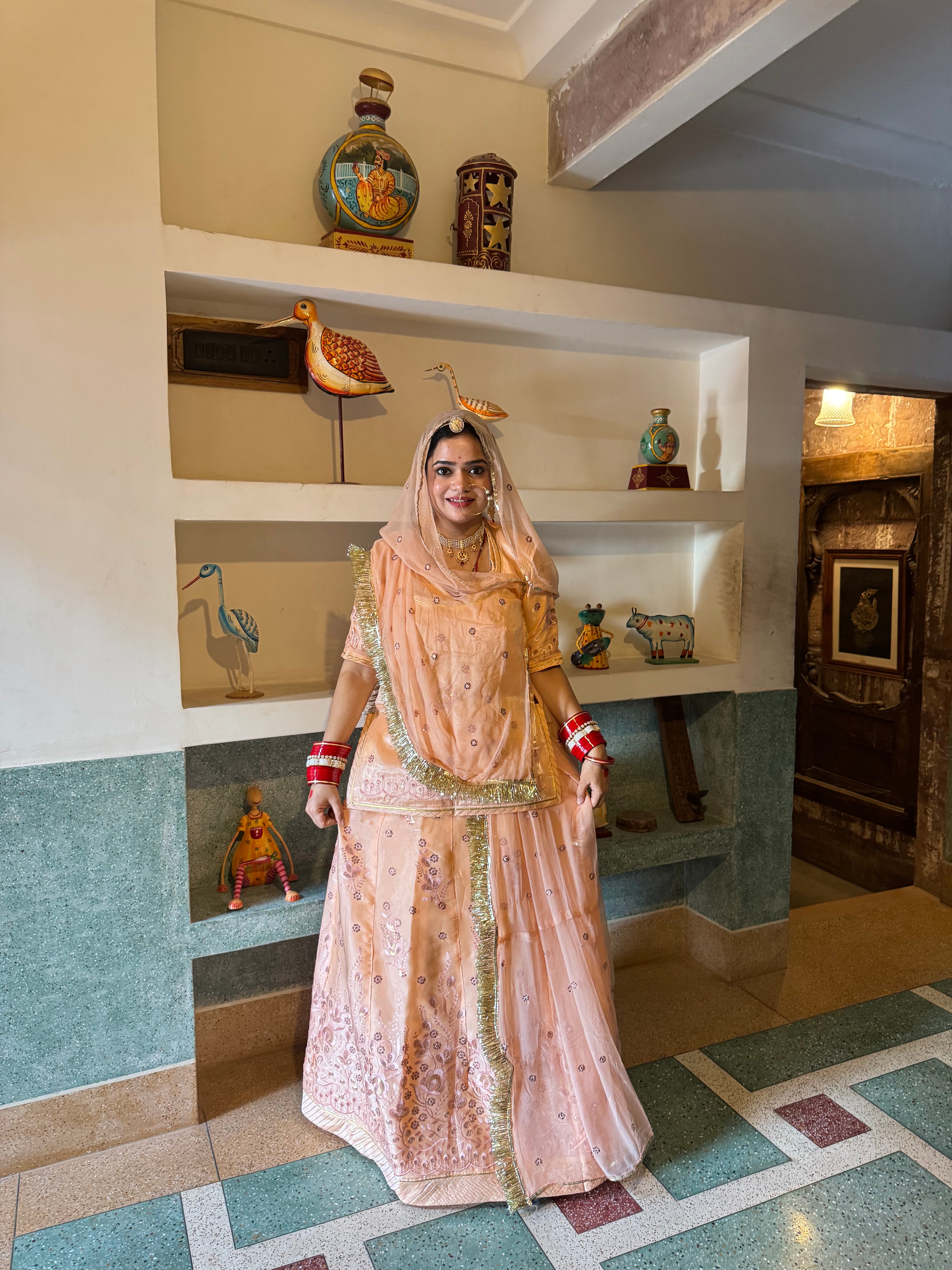 Bindani Elegant Peach Tissue Poshak with Button-Embellished Odhna