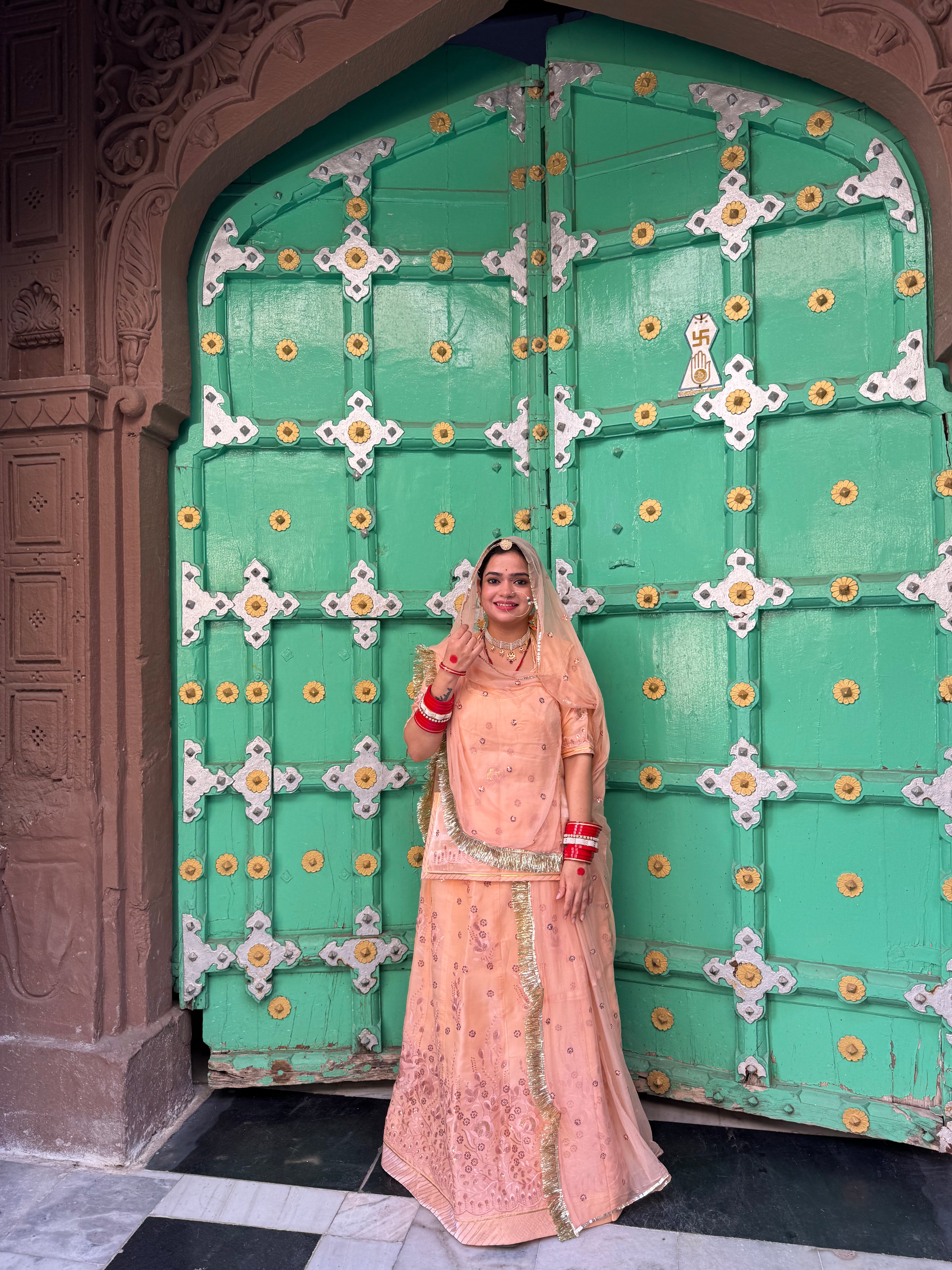 Bindani Elegant Peach Tissue Poshak with Button-Embellished Odhna