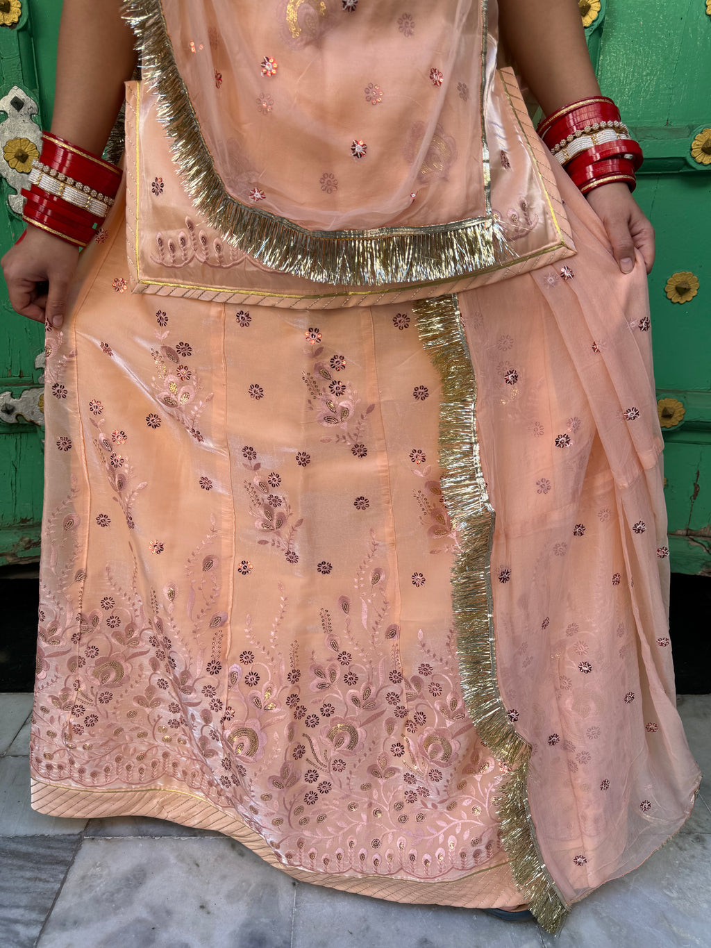 Bindani Elegant Peach Tissue Poshak with Button-Embellished Odhna