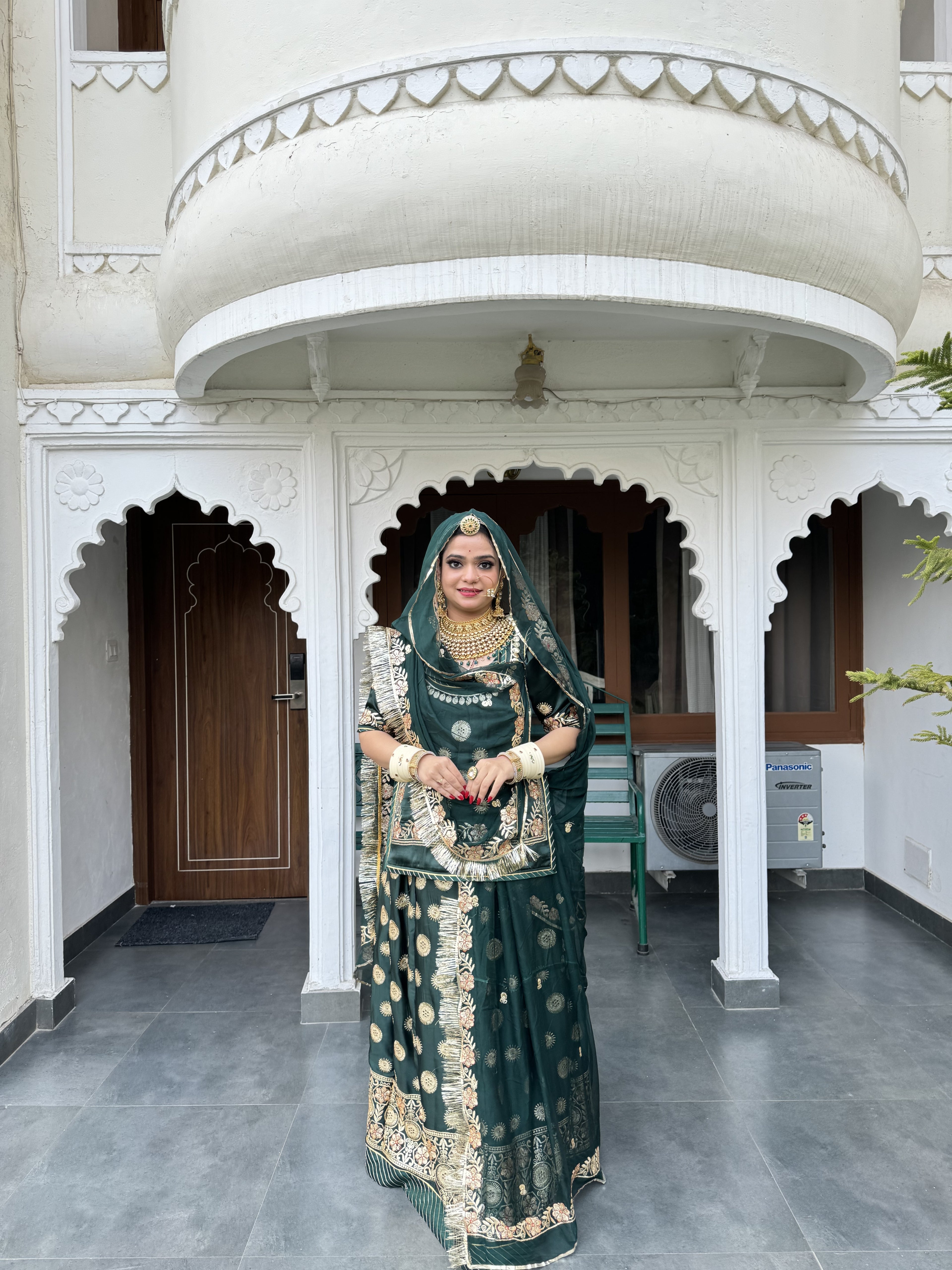 Emerald Elegance: A Green Satin Poshak Adorned with Zari Brilliance