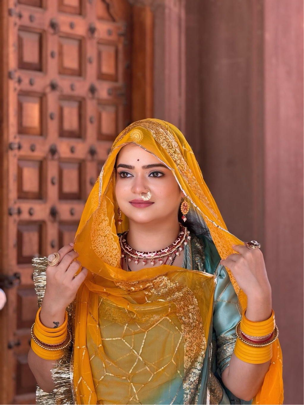 Bindani Emerald Grace: The Green Organza Poshak with Contrast Odhna