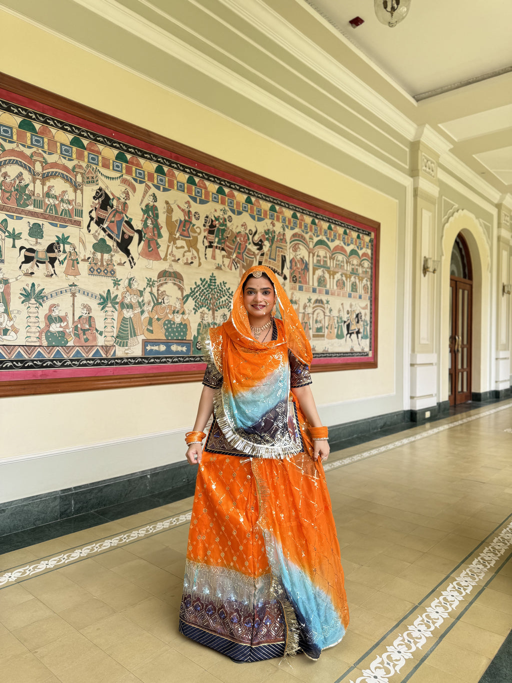 Radiant Sunset: Orange Organza Poshak with a Touch of Blue