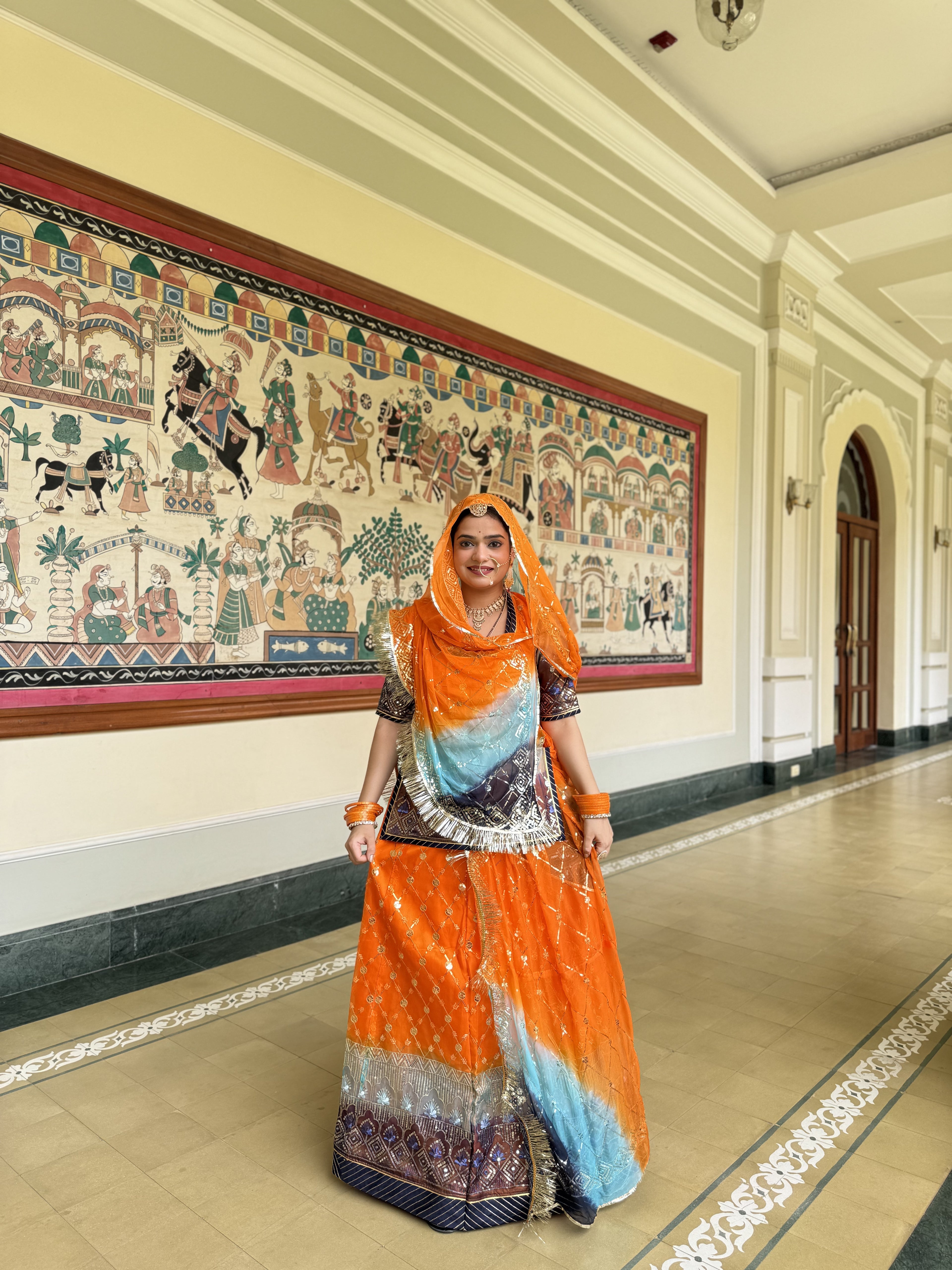 Radiant Sunset: Orange Organza Poshak with a Touch of Blue