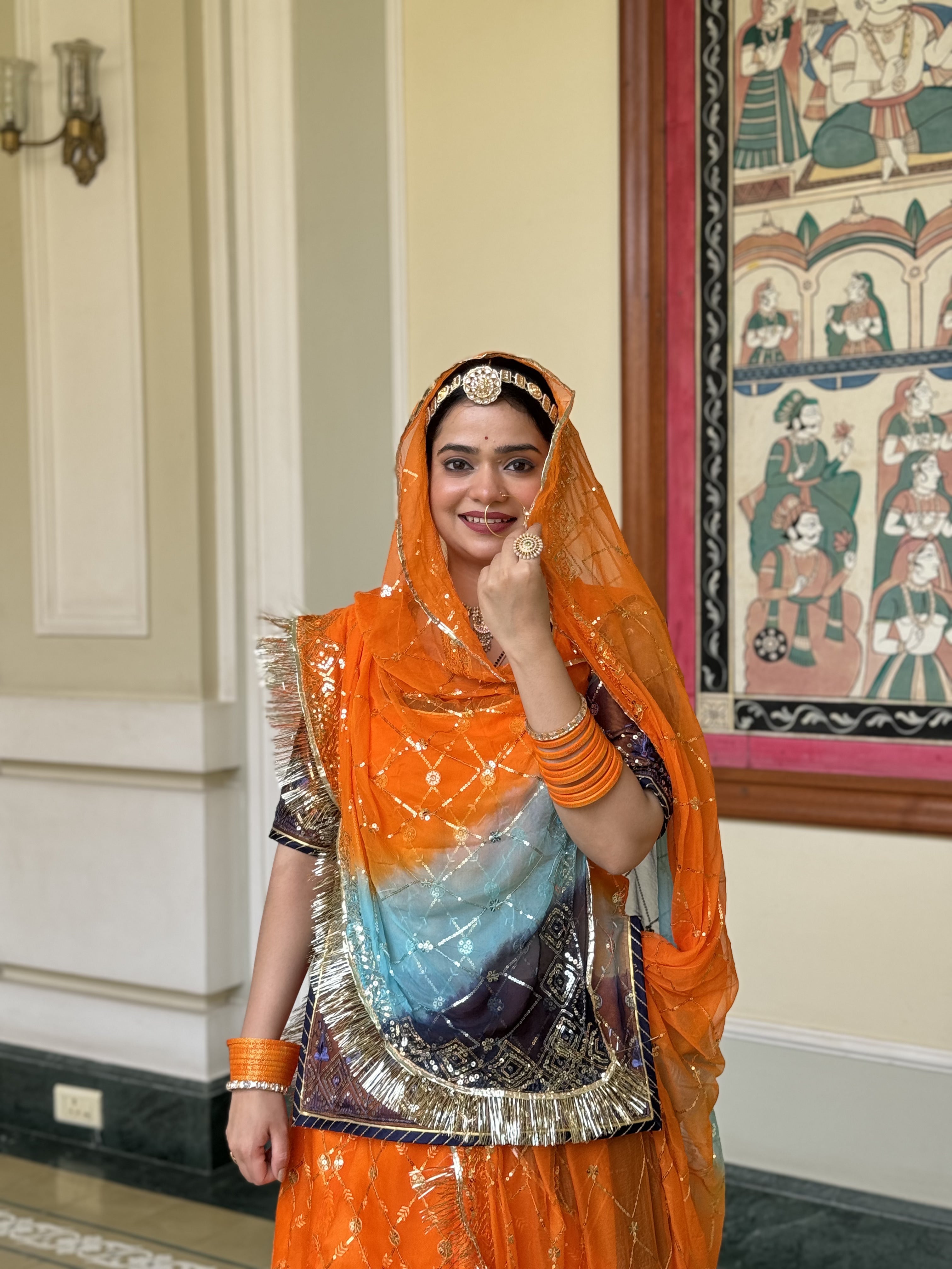 Radiant Sunset: Orange Organza Poshak with a Touch of Blue