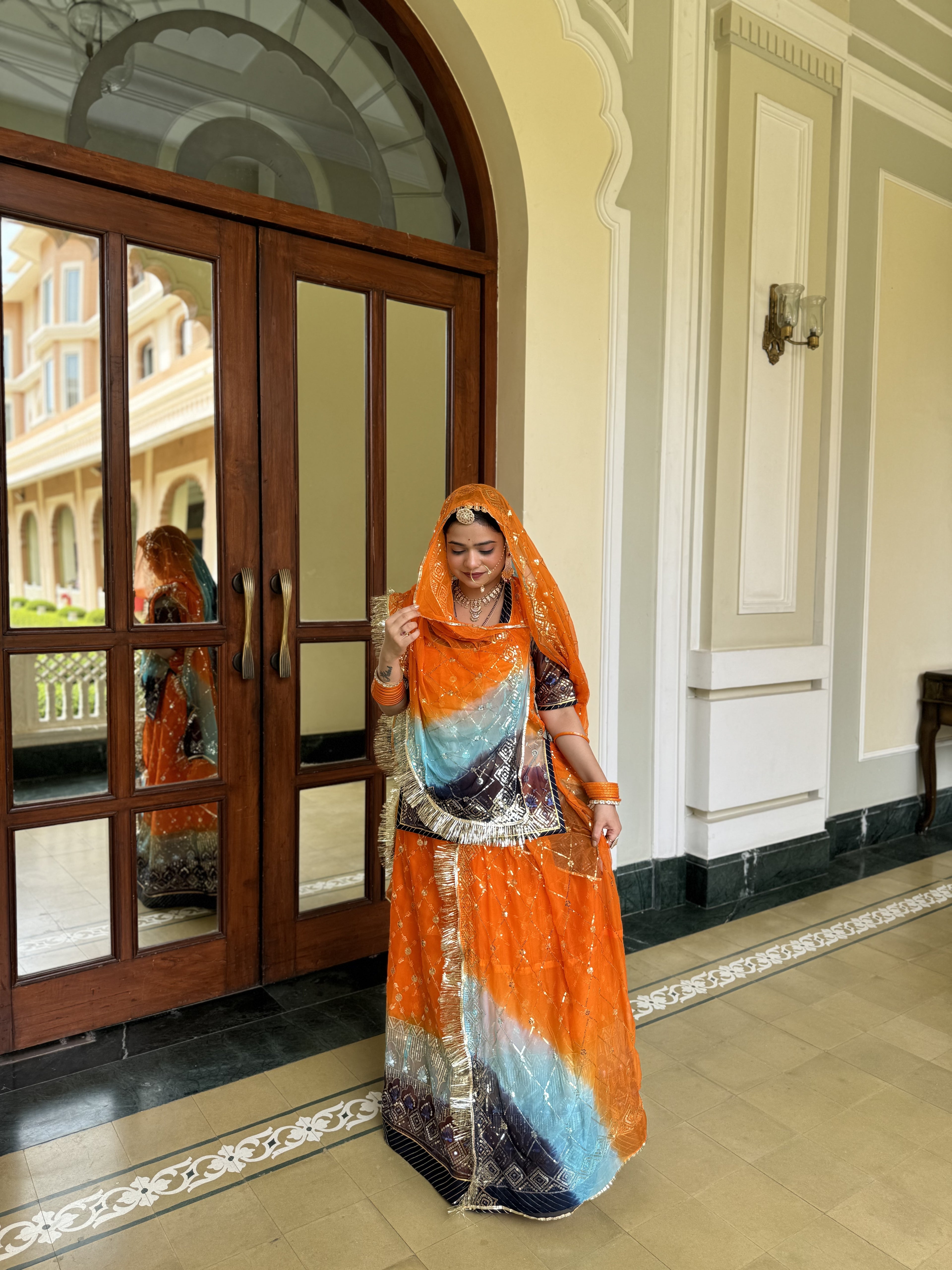 Radiant Sunset: Orange Organza Poshak with a Touch of Blue