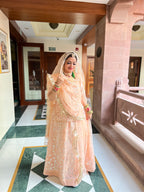 Peachy Perfection: Net Poshak Ensemble with Sheer Elegance